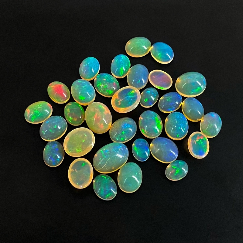 54.40 Cts. Ethiopian Opal 8x6-13x9mm Smooth Oval Shape AAA+ Grade Cabochons Parcel - Total 32 Pcs.