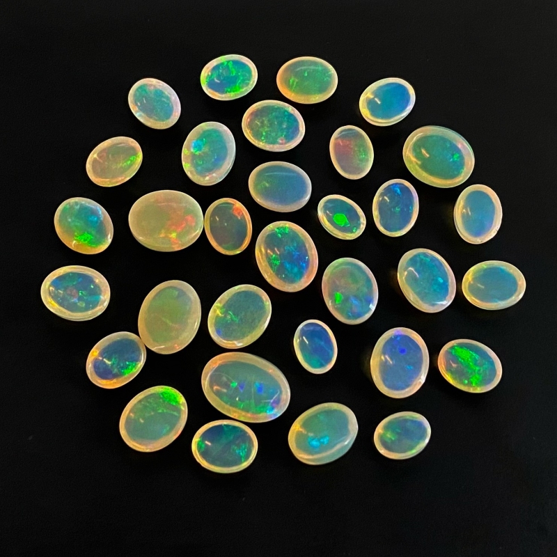 54.40 Cts. Ethiopian Opal 8x6-13x9mm Smooth Oval Shape AAA+ Grade Cabochons Parcel - Total 32 Pcs.