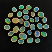 54.40 Cts. Ethiopian Opal 8x6-13x9mm Smooth Oval Shape AAA+ Grade Cabochons Parcel - Total 32 Pcs.