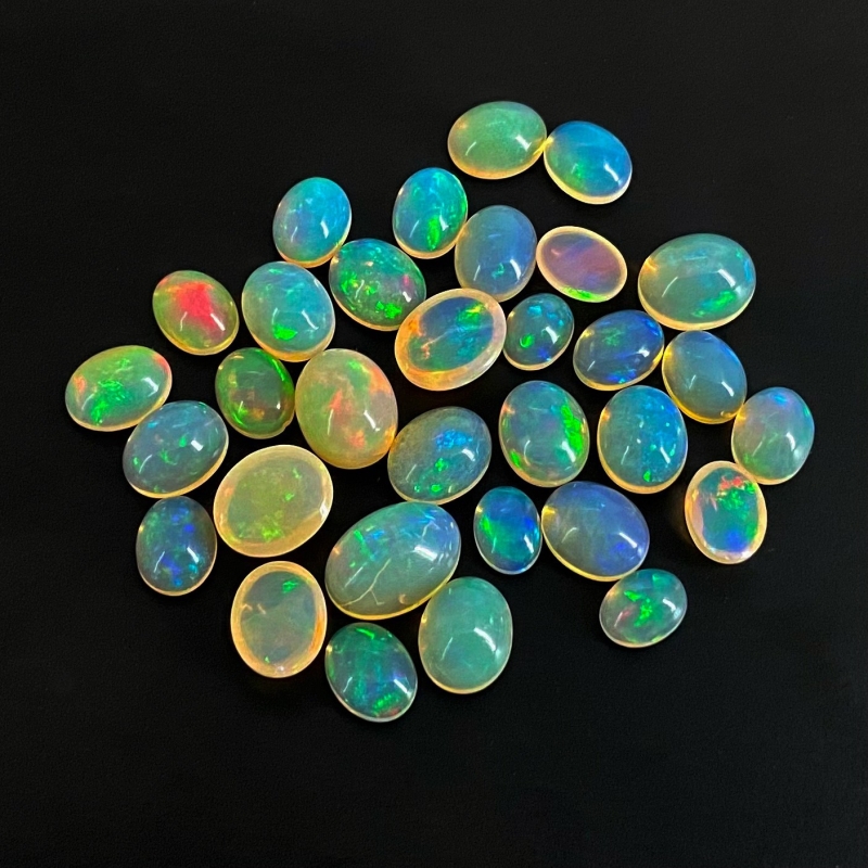54.40 Cts. Ethiopian Opal 8x6-13x9mm Smooth Oval Shape AAA+ Grade Cabochons Parcel - Total 32 Pcs.