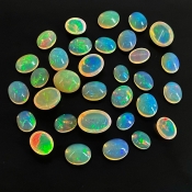 54.40 Cts. Ethiopian Opal 8x6-13x9mm Smooth Oval Shape AAA+ Grade Cabochons Parcel - Total 32 Pcs.