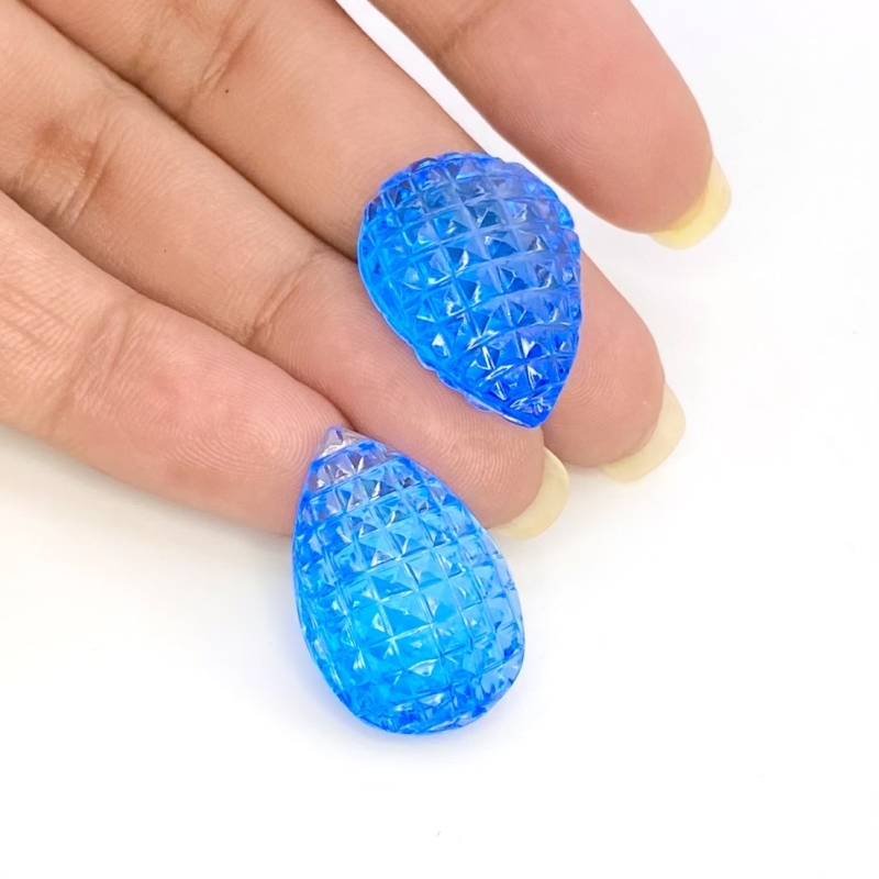 49.78 Cts. Swiss Blue Topaz 23x16mm Carved Pear Shape AAA+ Grade Matched Gemstone Carvings Pair - Total 2 Pcs.